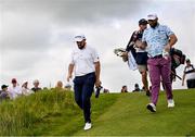 19 July 2025; Shane Lowry of Ireland and Jon Rahm of Spain walk down to the second fairway during day three of The 153rd Open Championship at Royal Portrush Golf Club in Portrush, Antrim. Photo by Ramsey Cardy/Sportsfile
