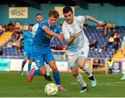 18 July 2025; Glenn Shannon of St Mochta's in action against Conan Noonan of Waterford during the Sports Direct Men’s FAI Cup second round match between Waterford and St Mochta’s at the Regional Sports Centre in Waterford. Photo by Michael P Ryan/Sportsfile