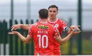 19 July 2025; Sean Boyd, right, congratulates his Shelbourne team-mate John Martin, 10, on scoring their third goal during the Sports Direct Men’s FAI Cup second round match between Fairview Rangers and Shelbourne at Singland Park in Limerick. Photo by Stephen McCarthy/Sportsfile