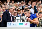 20 July 2025; Ronan Maher of Tipperary kisses lifts the Liam MacCarthy Cup alongside Uachtarán Chumann Lúthchleas Gael Jarlath Burns after his side's victory in the GAA Hurling All-Ireland Senior Championship final match between Cork and Tipperary at Croke Park in Dublin. Photo by Stephen McCarthy/Sportsfile