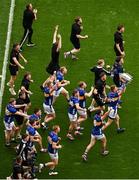 20 July 2025; Tipperary players including John McGrath, 14, run toward Hill 16 with the Liam MacCarthy Cup after their side's victory in the GAA Hurling All-Ireland Senior Championship final match between Cork and Tipperary at Croke Park in Dublin. Photo by David Fitzgerald/Sportsfile