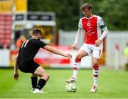 20 July 2025; Chris Forrester of St Patrick's Athletic in action against Craig Walsh of UCC during the Sports Direct Men’s FAI Cup second round match between St. Patrick’s Athletic and UCC at Richmond Park in Dublin. Photo by Michael P Ryan/Sportsfile