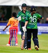 20 July 2025; Gaby Lewis of Ireland celebrates with teammate Lara Paul, 16, after hitting a boundary during match one of the Women's T20 International Series between Ireland and Zimbabwe at Pembroke Cricket Club in Dublin. Photo by Ben McShane/Sportsfile