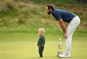 20 July 2025; Scottie Scheffler of USA, with his son Bennett, celebrates with the Claret Jug after winning The 153rd Open Championship at Royal Portrush Golf Club in Portrush, Antrim. Photo by Ramsey Cardy/Sportsfile