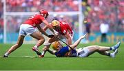 20 July 2025; Jake Morris of Tipperary passes, after losing his boot, in action against Ciarán Joyce, left, and Declan Dalton of Cork during the GAA Hurling All-Ireland Senior Championship final match between Cork and Tipperary at Croke Park in Dublin. Photo by Piaras Ó Mídheach/Sportsfile