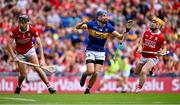 20 July 2025; John McGrath of Tipperary celebrates scoring his side's first goal as Cork players Eoin Downey and Niall O'Leary, right, after the GAA Hurling All-Ireland Senior Championship final match between Cork and Tipperary at Croke Park in Dublin. Photo by Piaras Ó Mídheach/Sportsfile