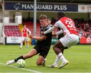 20 July 2025; Craig Walsh of UCC in action against Al-Amin Kazeem of St Patrick's Athletic during the Sports Direct Men’s FAI Cup second round match between St. Patrick’s Athletic and UCC at Richmond Park in Dublin. Photo by Michael P Ryan/Sportsfile