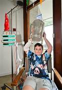 21 July 2025; Thomas Paul Brophy Barry, aged 10, with the Liam MacCarthy Cup at Children's Health Ireland, Crumlin in Dublin after winning The Liam MacCarthy Cup at Croke Park on Sunday. Photo by Sam Barnes/Sportsfile