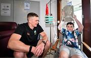 21 July 2025; All-Ireland Hurling Champions Tipperary captain Ronan Maher, left, with Thomas Paul Brophy Barry, aged 10, and the Liam MacCarthy Cup at Children's Health Ireland, Crumlin in Dublin after winning The Liam MacCarthy Cup at Croke Park on Sunday. Photo by Sam Barnes/Sportsfile