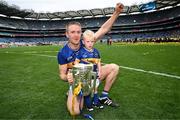 20 July 2025; Noel McGrath of Tipperary and his son Sam celebrate with the Liam MacCarthy cup after his side's victory in the GAA Hurling All-Ireland Senior Championship final match between Cork and Tipperary at Croke Park in Dublin. Photo by Stephen McCarthy/Sportsfile