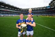 20 July 2025; Tipperary's Seamus Kennedy, left, and Noel McGrath, with his son Sam, celebrate with the Liam MacCarthy cup after their side's victory in the GAA Hurling All-Ireland Senior Championship final match between Cork and Tipperary at Croke Park in Dublin. Photo by Stephen McCarthy/Sportsfile