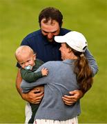 20 July 2025; Scottie Scheffler of USA celebrates with his wife Meredith and son Bennett after winning the final round of The 153rd Open Championship at Royal Portrush Golf Club in Portrush, Antrim. Photo by Ramsey Cardy/Sportsfile
