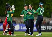 22 July 2025; Ireland bowler Lara McBride, centre, celebrates the wicket of Chipo Spiwe Tiripano of Zimbabwe with teammates including Gaby Lewis, right, during match two of the Women's T20 International Series between Ireland and Zimbabwe at Pembroke Cricket Club in Dublin. Photo by Sam Barnes/Sportsfile