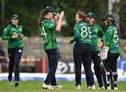 22 July 2025; Ireland bowler Cara Murray, centre, celebrates the wicket of Nyasha Gwanzura of Zimbabwe with teammates including Orla Prendergast, left, during match two of the Women's T20 International Series between Ireland and Zimbabwe at Pembroke Cricket Club in Dublin. Photo by Sam Barnes/Sportsfile