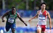 22 July 2025; Toluwabori Akinola, from Balbriggan in Dublin, representing University College Dublin and Ireland, left, crosses the line to finish third in the semi-final of the men's 100m during day six of the FISU World University Games 2025 at Lohrheidestadion in Bochum, Germany. Photo by Shauna Clinton/Sportsfile