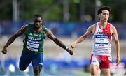 22 July 2025; Toluwabori Akinola, from Balbriggan in Dublin, representing University College Dublin and Ireland, left, crosses the line to finish third in the semi-final of the men's 100m during day six of the FISU World University Games 2025 at Lohrheidestadion in Bochum, Germany. Photo by Shauna Clinton/Sportsfile