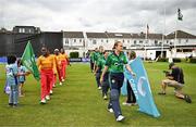 22 July 2025; Zimbabwe captain Chipo Spiwe Tiripano, left, and Ireland captain Gaby Lewis lead out their teams before match two of the Women's T20 International Series between Ireland and Zimbabwe at Pembroke Cricket Club in Dublin. Photo by Sam Barnes/Sportsfile
