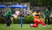 23 July 2025; Zimbabwe batter Chipo Spiwe Tiripano plays a shot, watched by Ireland wicketkeeper Amy Hunter, during match three of the Women's T20 International Series between Ireland and Zimbabwe at Sydney Parade in Dublin. Photo by Seb Daly/Sportsfile