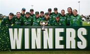 23 July 2025; Ireland players celebrate with the trophy after winning match three and taking the Women's T20 International Series between Ireland and Zimbabwe at Sydney Parade in Dublin. Photo by Seb Daly/Sportsfile