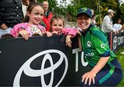 23 July 2025; Ireland's Laura Delany with supporters after match three of the Women's T20 International Series between Ireland and Zimbabwe at Sydney Parade in Dublin. Photo by Seb Daly/Sportsfile