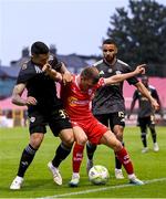 23 July 2025; James Norris of Shelbourne in action against Pedro Bicalho, left, and Leandro Andrade of Qarabag during the UEFA Champions League Second Qualifying Round first leg match between Shelbourne and Qarabag FK at Tolka Park in Dublin. Photo by Stephen McCarthy/Sportsfile