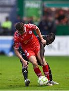 23 July 2025; JJ Lunney of Shelbourne is tackled by Emmanuel Addai of Qarabag during the UEFA Champions League Second Qualifying Round first leg match between Shelbourne and Qarabag FK at Tolka Park in Dublin. Photo by Ben McShane/Sportsfile