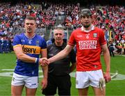 20 July 2025; The two captains, Ronan Maher of Tipperary and Robert Downey of Cork, shake hands across referee Liam Gordon before the GAA Hurling All-Ireland Senior Championship final match between Cork and Tipperary at Croke Park in Dublin. Photo by Ray McManus/Sportsfile