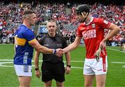 20 July 2025; The two captains, Ronan Maher of Tipperary and Robert Downey of Cork, shake hands across referee Liam Gordon before the GAA Hurling All-Ireland Senior Championship final match between Cork and Tipperary at Croke Park in Dublin. Photo by Ray McManus/Sportsfile