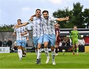 25 July 2025; Pádraig Amond of Waterford celebrates with team-mate Grant Horton, right, after scoring their side's fourth goal, from a penalty, during the SSE Airtricity Men's Premier Division match between Galway United and Waterford at Eamonn Deacy Park in Galway. Photo by Piaras Ó Mídheach/Sportsfile