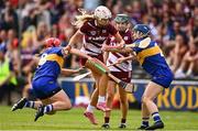 26 July 2025; Olwen Rabbitte of Galway gets through the tackles of Aoife McGrath, left, and Julieanne Bourke of Tipperary during the Glen Dimplex All-Ireland Camogie Senior Championship semi-final match between Galway and Tipperary at UPMC Nowlan Park, Kilkenny. Photo by Ben McShane/Sportsfile