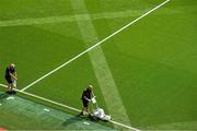 27 July 2025; Lead groundsman Darren Jepson painting the lines as matchday volunteer Declan Magee places the flags before the GAA Football All-Ireland Senior Championship final match between Kerry and Donegal at Croke Park in Dublin. Photo by Ray McManus/Sportsfile