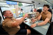 28 July 2025; David Clifford, right, head of athletic development Jason McGahan and county board chairman Patrick O'Sullivan, with the Sam Maguire cup on the teams departure from Sallins & Naas Train Station in Kildare after winning the GAA Football All-Ireland Senior Championship final at Croke Park on Sunday. Photo by Ramsey Cardy/Sportsfile