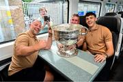 28 July 2025; Kerry head of athletic development Jason McGahan, left, Kerry county board chairman Patrick O'Sullivan, centre, and David Clifford with the Sam Maguire cup on the teams departure from Sallins & Naas Train Station in Kildare after winning the GAA Football All-Ireland Senior Championship final at Croke Park on Sunday. Photo by Ramsey Cardy/Sportsfile