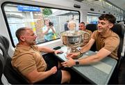 28 July 2025; David Clifford, right, head of athletic development Jason McGahan and county board chairman Patrick O'Sullivan, with the Sam Maguire cup on the teams departure from Sallins & Naas Train Station in Kildare after winning the GAA Football All-Ireland Senior Championship final at Croke Park on Sunday. Photo by Ramsey Cardy/Sportsfile