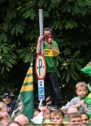 28 July 2025; A Kerry supporter atop a sign-post during homecoming celebrations in Tralee for Kerry, the All-Ireland Senior Football Champions, after their victory over Donegal in the GAA Football All-Ireland Senior Championship final at Croke Park on Sunday. Photo by Piaras Ó Mídheach/Sportsfile