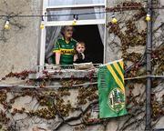 28 July 2025; Tralee residents look on from their window during homecoming celebrations for Kerry, the All-Ireland Senior Football Champions, following their victory over Donegal in the GAA Football All-Ireland Senior Championship final at Croke Park on Sunday. Photo by Piaras Ó Mídheach/Sportsfile