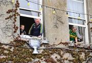 28 July 2025; Tralee residents hang a replica of the Sam Maguire Cup from their window during homecoming celebrations for Kerry, the All-Ireland Senior Football Champions, after their victory over Donegal in the GAA Football All-Ireland Senior Championship final at Croke Park on Sunday. Photo by Piaras Ó Mídheach/Sportsfile