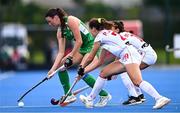 29 July 2025; Emily Kealy of Ireland in action against Paula Jimenez, front, and Marta Segu of Spain during the women's hockey international match between Ireland and Spain at the Sport Ireland Campus in Dublin. Photo by Ben McShane/Sportsfile