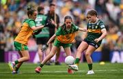 27 July 2025; Emmy Millea, St Aidan's NS, Kilmanagh, Kilkenny, representing Kerry, in action against Lucy Murphy, Breaffy NS, Breaffy, Mayo, representing Donegal, and Grace McGonigle, Gaelscoil Cois Feabhaill, Moville, Donegal, during the GAA INTO Cumann na mBunscol Respect Exhibition Go Games at the GAA Football All-Ireland Senior Championship final match between Kerry and Donegal at Croke Park in Dublin. Photo by Ramsey Cardy/Sportsfile