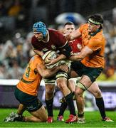 2 August 2025; Tadhg Beirne of British & Irish Lions is tackled by Australia players Joseph-Aukuso Suaalii, left, and Tom Hooper during the third test match between Australia and the British & Irish Lions at Accor Stadium in Sydney, Australia. Photo by Brendan Moran/Sportsfile