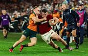 2 August 2025; Dan Sheehan of British & Irish Lions is tackled by Max Jorgensen of Australia during the third test match between Australia and the British & Irish Lions at Accor Stadium in Sydney, Australia. Photo by Steve Christo/Sportsfile