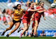 3 August 2025; Eimear Murray of Louth makes a pass despite the efforts of Omolara Dahunsi of Antrim during the TG4 All-Ireland Ladies Football Junior Championship final match between Antrim and Louth at Croke Park in Dublin. Photo by Shauna Clinton/Sportsfile