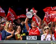 3 August 2025; Louth captain Áine Breen lifts The West County Hotel cup, alongside Uachtarán Cumann Peil Gael na mBan, Trina Murray, left, after her side's victory in the TG4 All-Ireland Ladies Football Junior Championship final match between Antrim and Louth at Croke Park in Dublin. Photo by Shauna Clinton/Sportsfile