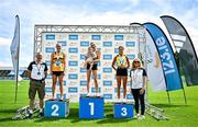 3 August 2025; Senior women's 5000m medallists Niamh Allen of Leevale AC, Cork, centre, gold, with her 11 month old daughter Lily, Anika Thompson of Leevale AC, silver, left, and Fiona Everard of Bandon AC, Cork, bronze, right, alongside Athletics Ireland Event Controller and Safety Officer George Maybury, far left, and Athletics Ireland President Brid Golden, far right, during day two of the 153rd 123.ie National Track & Field Senior Championships at Morton Stadium in Dublin. Photo by Sam Barnes/Sportsfile