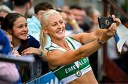 3 August 2025; Sarah Lavin of Emerald AC, Limerick, takes a selfie with supporters after winning the senior women's 100m hurdles final during day two of the 153rd 123.ie National Track & Field Senior Championships at Morton Stadium in Dublin. Photo by Sam Barnes/Sportsfile
