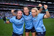 3 August 2025; Dublin players, from left, Hannah Leahy, Rachel Hartnett and Jodi Egan celebrate after their side's victory in the TG4 All-Ireland Ladies Football Senior Championship final match between Dublin and Meath at Croke Park in Dublin. Photo by Shauna Clinton/Sportsfile