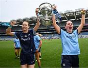 3 August 2025; Dublin players Katie Moran Tighe, left, and Ashling Nyhan celebrate with the Brendan Martin cup after their side's victory in the TG4 All-Ireland Ladies Football Senior Championship final match between Dublin and Meath at Croke Park in Dublin. Photo by Seb Daly/Sportsfile