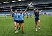 3 August 2025; Dublin players, from left, Jodi Egan, Chloe Darby and Abby Shiels celebrate with the Brendan Martin cup after their side's victory in the TG4 All-Ireland Ladies Football Senior Championship final match between Dublin and Meath at Croke Park in Dublin. Photo by Seb Daly/Sportsfile