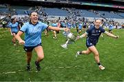 3 August 2025; Dublin players Chloe Darby, left, and Abby Shiels celebrate with the Brendan Martin cup after their side's victory in the TG4 All-Ireland Ladies Football Senior Championship final match between Dublin and Meath at Croke Park in Dublin. Photo by Seb Daly/Sportsfile