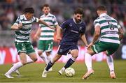 3 August 2025; Brandon Fleming of Derry City in action against Cory O'Sullivan, left, and Lee Grace of Shamrock Rovers during the SSE Airtricity Men's Premier Division match between Shamrock Rovers and Derry City at Tallaght Stadium in Dublin.  Photo by Ben McShane/Sportsfile